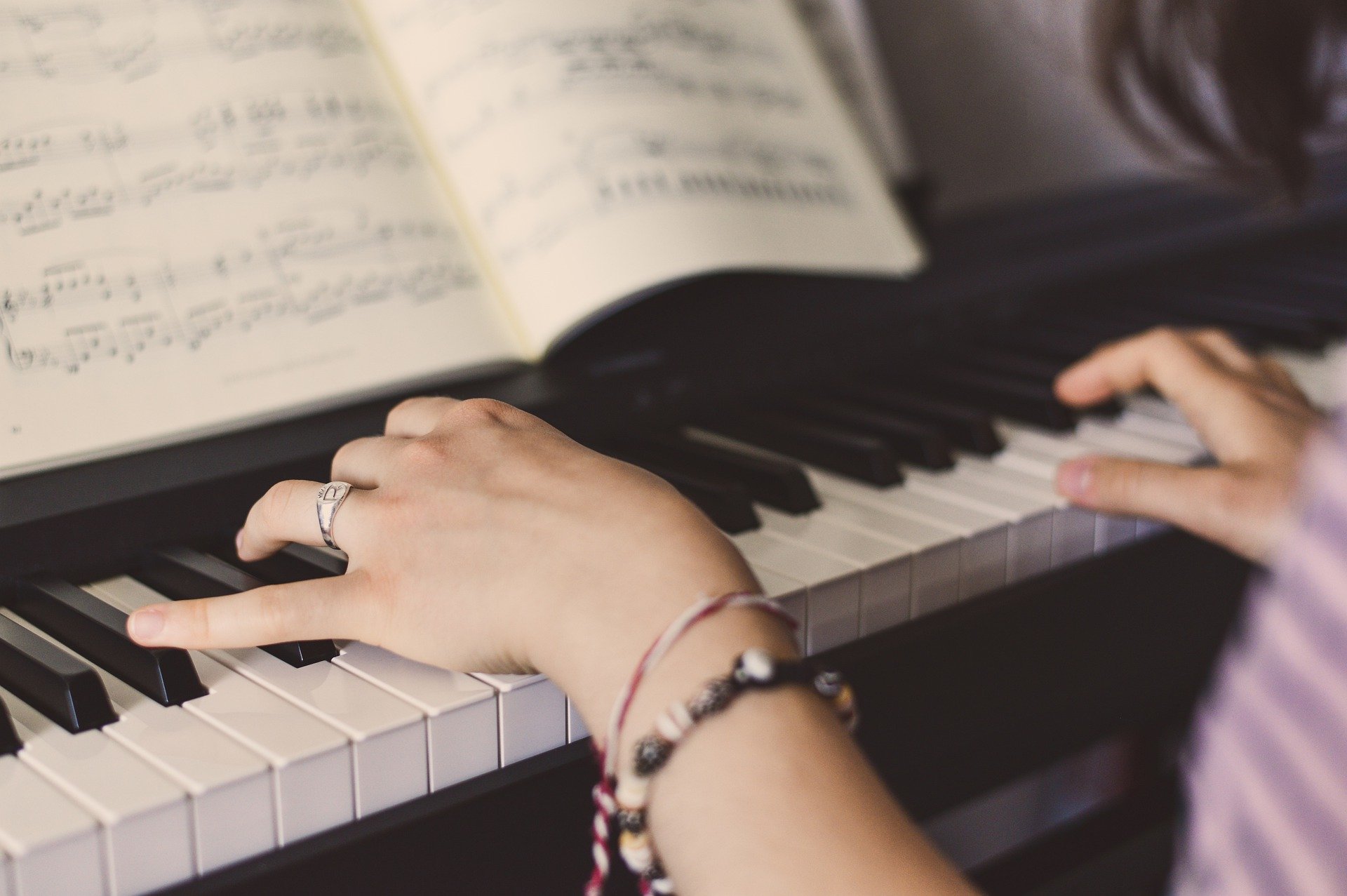 Klavier spielen lernen - Jugendliche bekommt Klavierunterricht bei einem Klavierlehrer